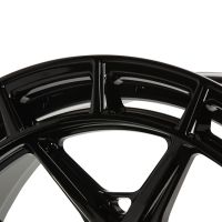 A glossy black wheel rim features sleek, angular spokes with a minimalist design, captured against a plain white background, highlighting its polished finish and modern aesthetic.