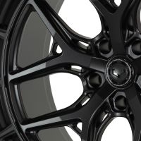 A black alloy wheel with intricate spoke design is displayed close-up against a white background. The central hub reads: "VOSSEN FORGED – ENGINEERED FORGED – VOSSEN WHEELS."