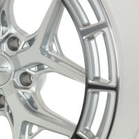 Silver alloy wheel features intricate spoke design, reflecting light. Center cap displays text: "VOSSEN HYBRID FORGED." Context is a simple white background highlighting the wheel's details.