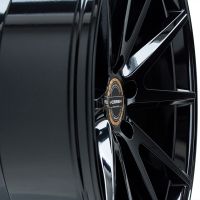 A glossy black alloy wheel with multiple spokes and a central hub displaying "VOSSEN" in a white, bold font; set against a minimalist white background.