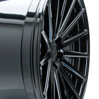 A glossy black alloy wheel with multiple spokes is viewed closely, featuring the text "VERDE REPUBLIC" in the center, against a plain white background.
