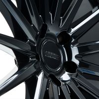 A shiny, black alloy wheel with multiple sleek spokes; the center hub has the inscription: "VOSSEN, HYBRID FORGED." The wheel is positioned against a neutral background.