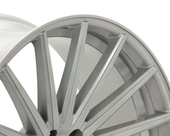 A silver alloy wheel with multiple sleek, intersecting spokes is shown in a close-up view, highlighting its metallic texture and modern design.