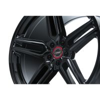 A black Vossen wheel with five spokes features a glossy finish, shown in close-up against a white background. Center cap text reads: "VOSSEN FORGED ENGINEERED ART."