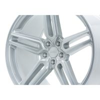 A silver alloy wheel features a five-spoke design, shown from a side angle against a plain, white background. Center hub text reads: "HRE PERFORMANCE WHEELS."