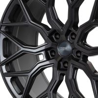 A black alloy wheel with an intricate, multi-spoke design is displayed prominently. The center cap reads "VOSSEN HYBRID FORGED." The background is plain, emphasizing the wheel's details.