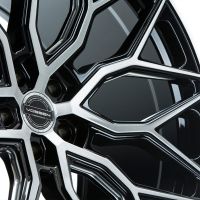 A black and silver alloy wheel is displayed featuring intricate spoke design, with the center cap reading "VOSSEN HYBRID FORGED" against a plain white background.