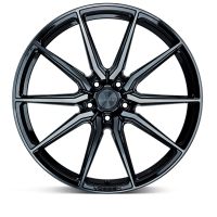 A glossy black alloy wheel features a multi-spoke design, radiating symmetrically from the center hub. "Vossen" is subtly inscribed on the wheel hub and rim edge, against a white background.
