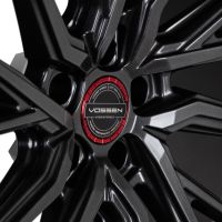 A Vossen wheel with a sleek, angular spoke design; central text reads: "VOSSEN, HYBRID-FORGED," surrounded by "VOSSEN WHEELS, EST. 2006, U.S.A., PASSION - PERFORMANCE - PRECISION" in black and red.