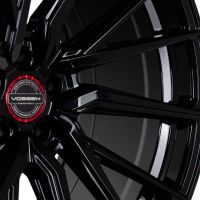 A glossy black alloy wheel with angular spokes, featuring a red center cap with "VOSSEN HYBRID FORGED" text, set against a plain white background.
