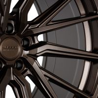 A bronze-colored alloy wheel with intricate multi-spoke design; embossed text reads "VOSSEN HF3 HYBRID FORGED," against a neutral background.