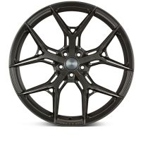 A black alloy wheel features a multi-spoke design in a studio setting, isolated against a white background. No visible text.