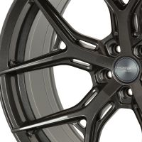 A metallic car wheel rim with intricate spoke design; "VOSSEN HYBRID FORGED" is inscribed on the center cap, set against a plain white background.