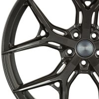 A metallic car wheel rim with intricate, angular spokes features the text "VOSSEN HYBRID FORGED" at its center, set against a plain white background.