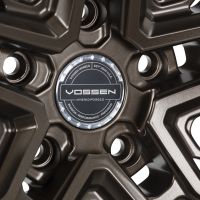 Bronze alloy wheel features five spokes with a polished center cap labeled “VOSSEN, HYBRID FORGED.” Surrounding text: “VOSSEN WHEELS EST. 2006 U.S.A PASSION • PERFORMANCE • PRECISION.”