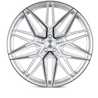 A silver alloy wheel with a geometric, multi-spoke design is displayed against a white background. The center cap reads "VOSSEN FORGED," and "VOSSEN" is engraved on the rim edge.