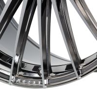A glossy chrome alloy wheel with sleek, curved spokes interlocking in a close-up view, highlighting the metallic finish in a well-lit studio setting.