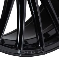 A glossy black car wheel rim with multiple spokes is prominently displayed, showcasing its sleek design and reflecting light. The brand name “VOSSEN” is engraved at the base.