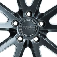A sleek metallic wheel rim features stylized angular spokes radiating from the center. Text on the hub reads "VOSSEN HYBRID FORGED." Positioned against a plain white background.