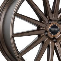 A bronze alloy wheel features multiple slim spokes radiating from a central hub with the 'VOSSEN' logo, set against a plain white background.