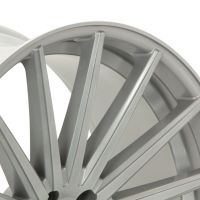 A silver alloy wheel features sleek, five-spoke design, photographed in close-up, highlighting its smooth, metallic surface. The background is plain white, emphasizing the wheel's form and material.